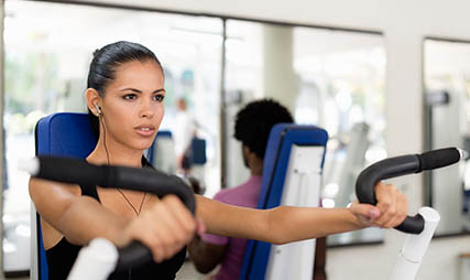 woman in gym using gym workout equipment