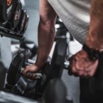 5 best dumbbell exercises person holding dumbbells home gym strength training