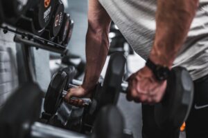 5 best dumbbell exercises person holding dumbbells home gym strength training