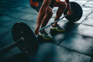 A person performing compound lifts during a full body exercises routine