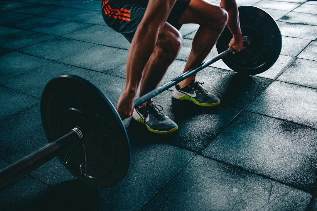 A person performing compound lifts during a full body exercises routine