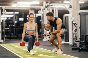 personal fitness instructor demonstrating proper dumbbell form