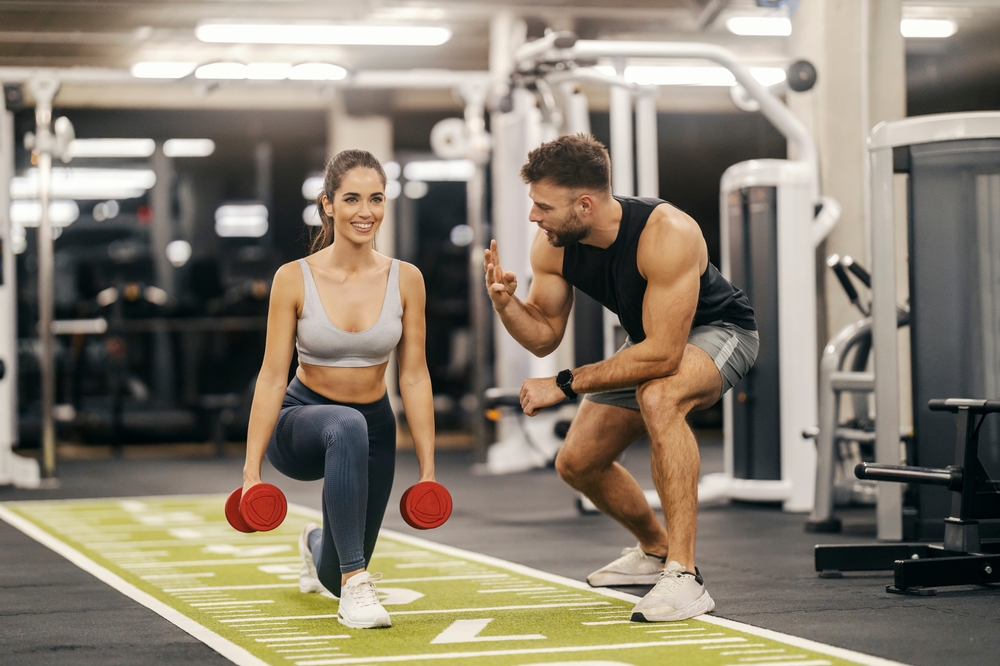 personal fitness instructor demonstrating proper dumbbell form